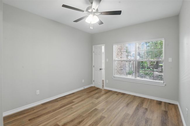 Empty room with baseboards, a ceiling fan, and wood finished floors | Image 12