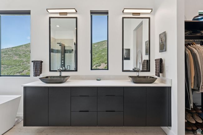Bathroom with a shower stall, double vanity, a walk in closet, and a soaking tub | Image 26