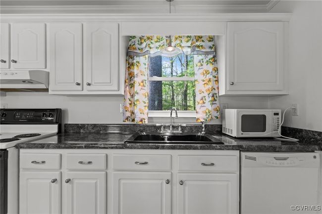 Kitchen featuring white cabinets, a sink, white appliances, and ventilation hood | Image 16