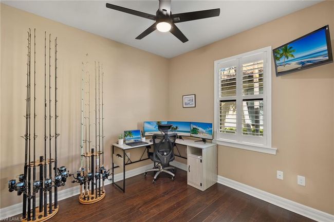 Office space featuring dark hardwood / wood-style floors and ceiling fan | Image 25