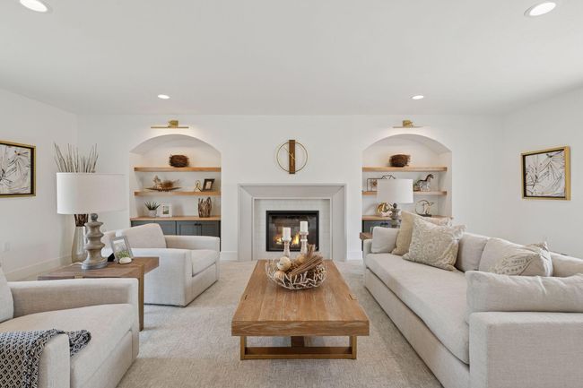 Upper level living area is amazing with all the natural light and is large enough for everyone. Beautiful built-ins with white oak floating shelves and arched opening are timeless. | Image 12