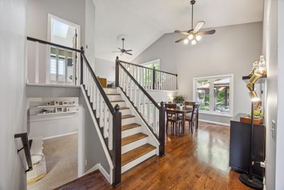 As you enter the home you will be greeted by vaulted ceilings and refinished hardwood floors that continue throughout the main and upper level. | Image 2