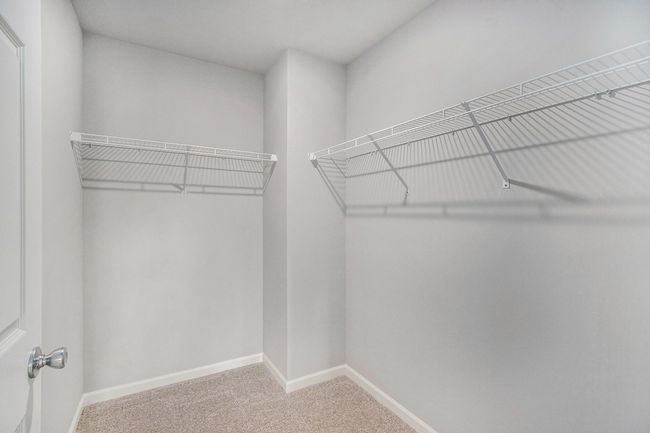 The luxurious primary suite includes a private bath and large walk-in closet. | Image 14