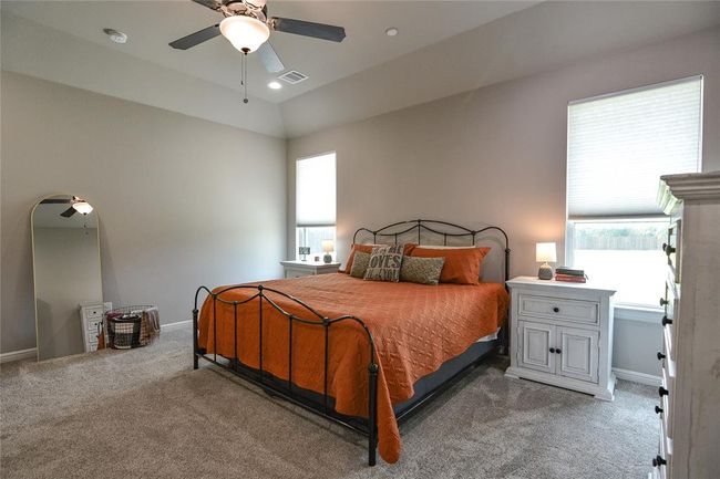 Carpeted bedroom with ceiling fan and vaulted ceiling | Image 19