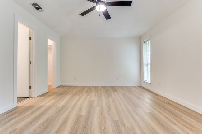 Empty room featuring light wood-style floors, a ceiling fan, and baseboards | Image 10
