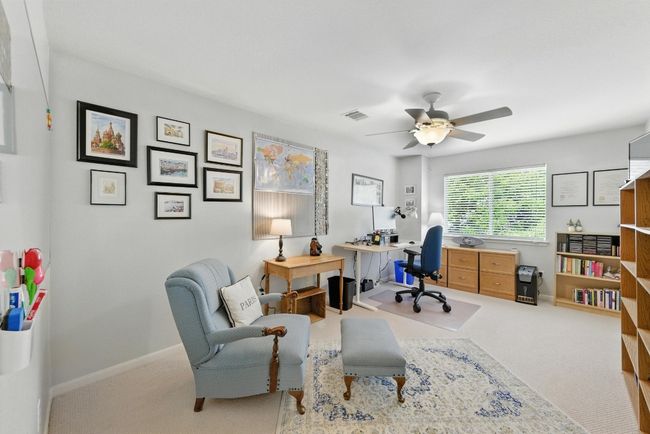 Carpeted office space with a ceiling fan and baseboards | Image 22