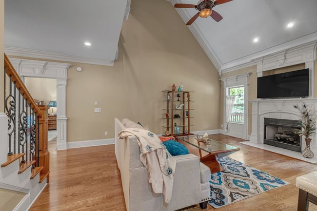 Relax by the fireplace and enjoy this lovely family room. | Image 13