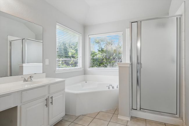 Full bathroom featuring vanity, a stall shower, and plenty of natural light | Image 20