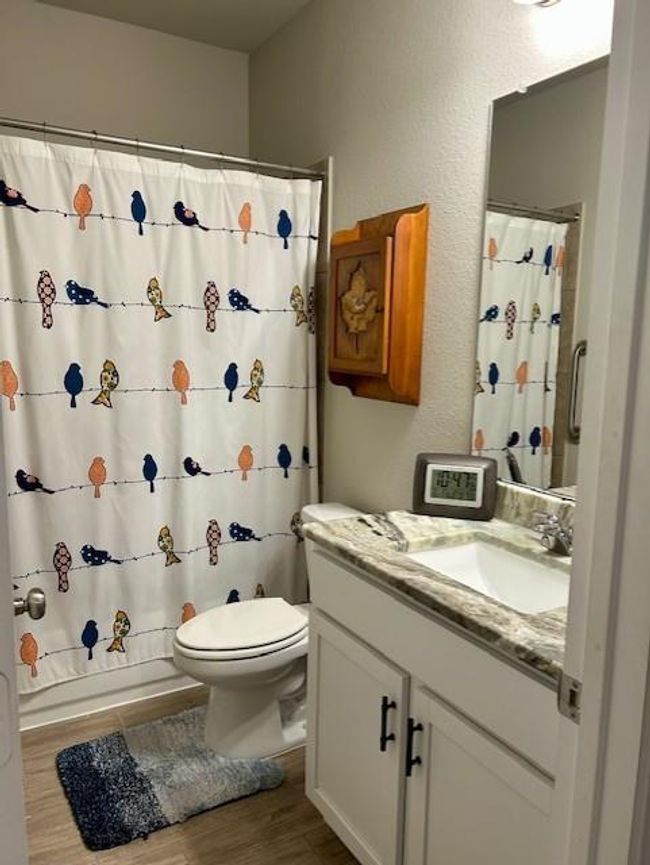 Charming guest bathroom with modern fixtures and playful decor, perfect for visitors. | Image 21