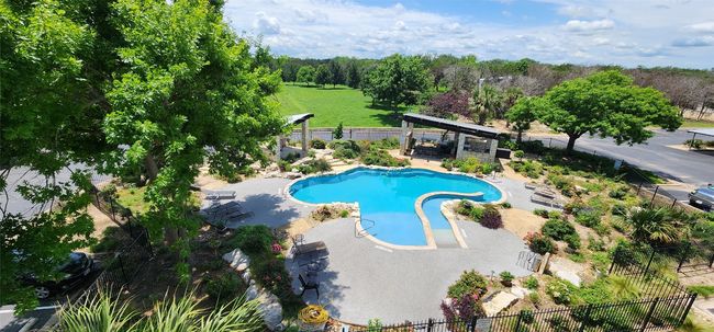 View of pool with fence, a gazebo, and a patio | Image 4