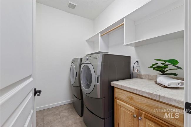 Laundry room with separate washer and dryer and cabinet space | Image 46