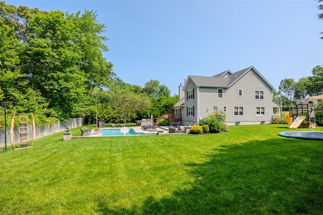 Fenced backyard featuring outdoor lounge area, a patio area, and a playground | Image 38