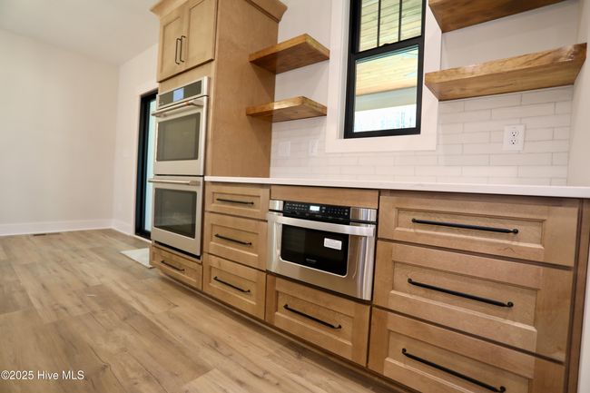 Custom details wood floating shelves + double ovens + microwave drawer | Image 15