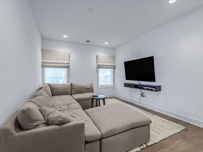 Living area with baseboards, visible vents, wood finished floors, and recessed lighting | Image 10