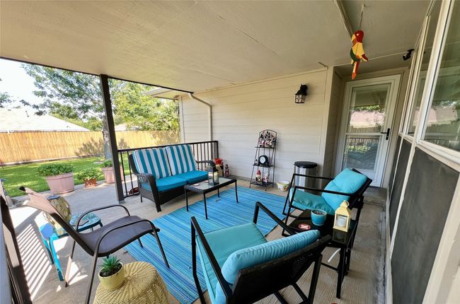 Covered Back Patio featuring an outdoor hangout area and fence | Image 36