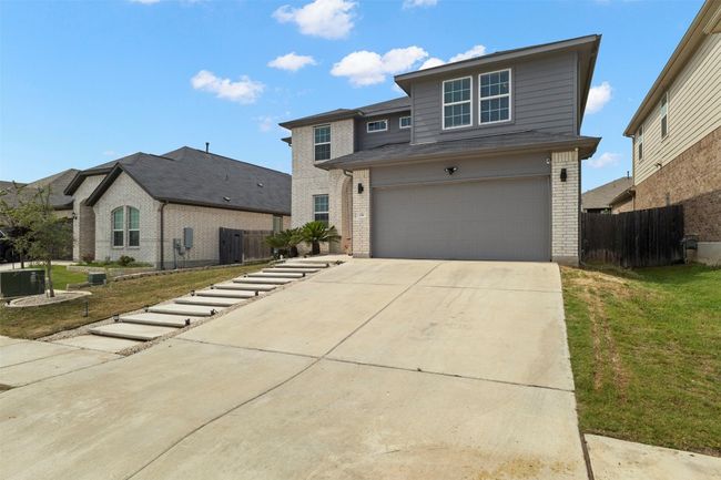 brick siding, driveway, and a garage | Image 31