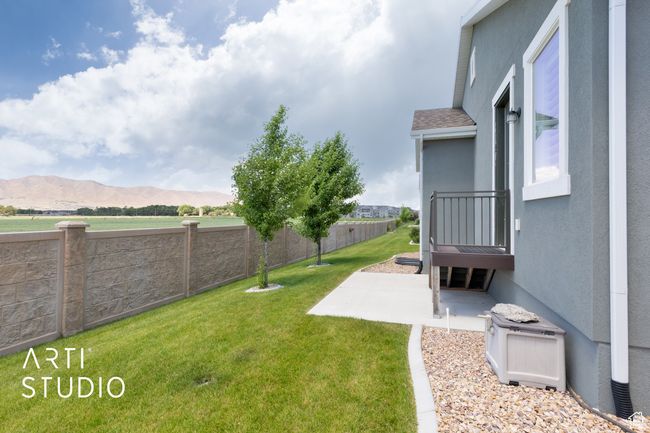 Fenced backyard with a patio and a mountain view | Image 36