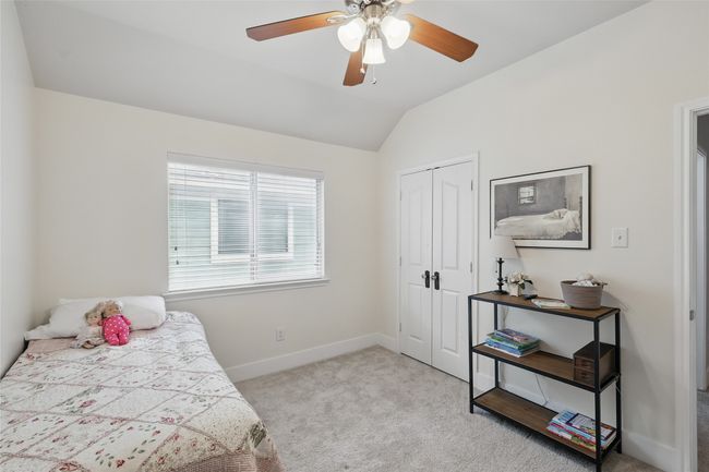 Carpeted bedroom with lofted ceiling, a closet, and a ceiling fan | Image 28