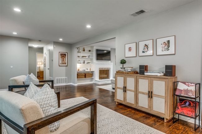 Living room featuring a fireplace, dark wood-style floors, and recessed lighting | Image 8