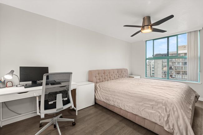 Bedroom with a ceiling fan and wood finished floors | Image 23