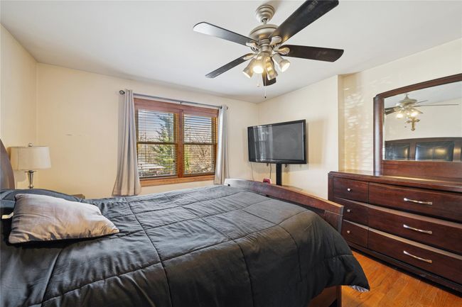 Bedroom with ceiling fan and wood finished floors | Image 36