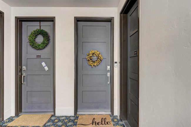 Doorway to property featuring stucco siding | Image 36