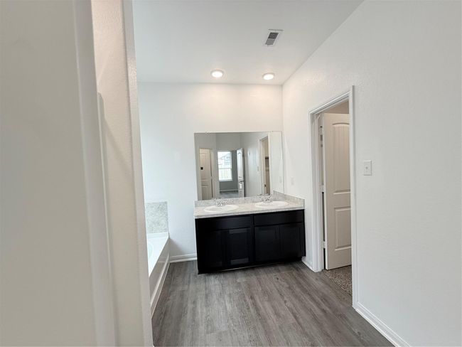 14501 SUGAR PINES DR - Primary bedroom with ensuite bathroom, dual sinks, separate tub and shower, and walk in closet | Image 32