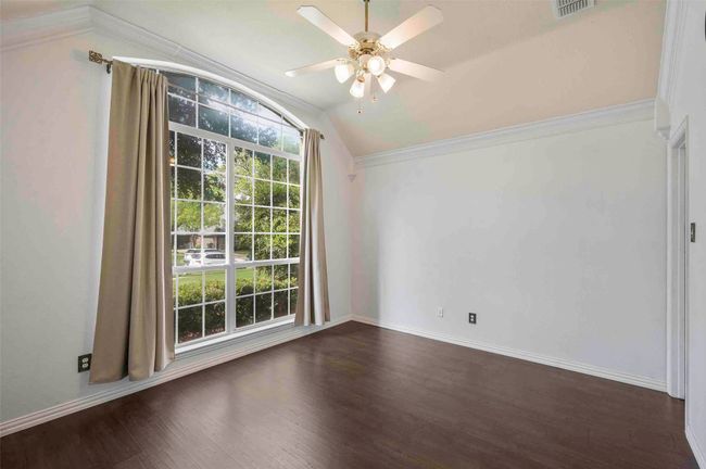 Spare room featuring lofted ceiling, ceiling fan, plenty of natural light, and visible vents | Image 9