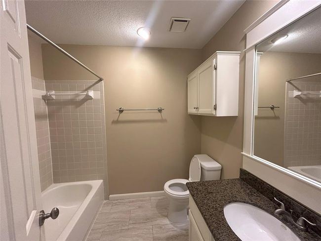 The primary bathroom also has decent space, overhead storage, granite countertops and a framed mirror. | Image 37
