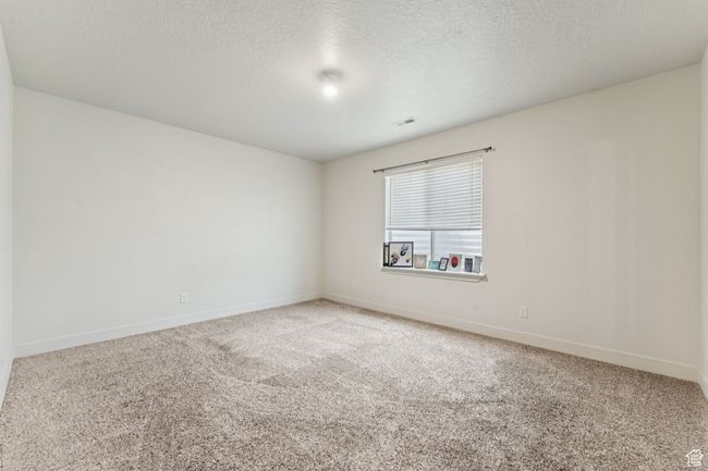 Spare room with carpet, baseboards, and a textured ceiling | Image 13