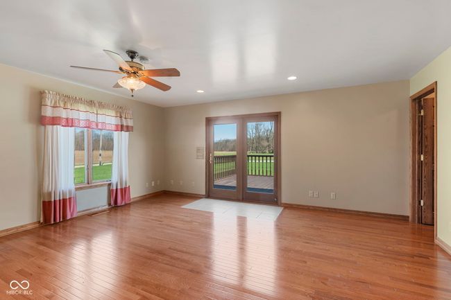 empty room with light wood finished floors, ceiling fan, recessed lighting, and baseboards | Image 18