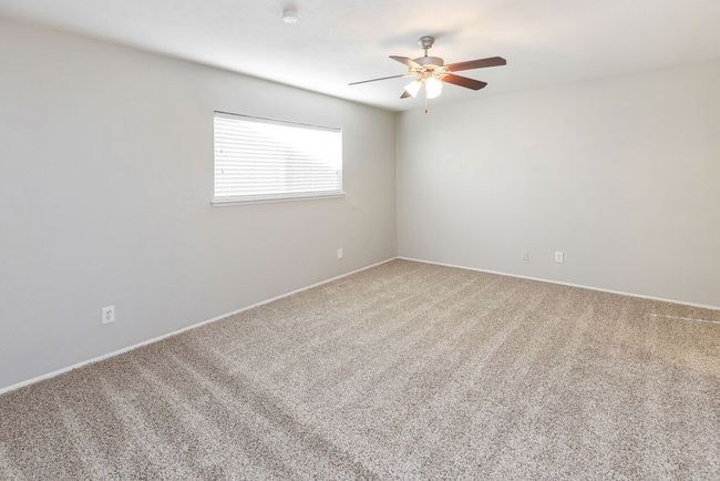 Spare room featuring light colored carpet and ceiling fan | Image 19
