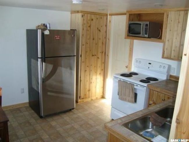 Kitchen featuring sink, stainless steel appliances, and tile patterned flooring | Image 43