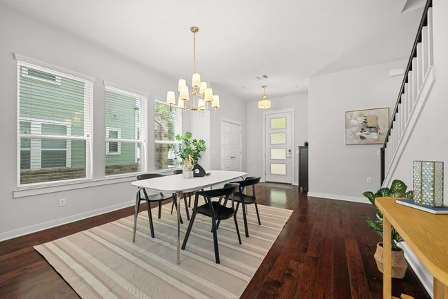 An eye-catching light fixture hangs above, illuminating the dining area with style, while the spacious layout easily accommodates a large table for gatherings of any size | Image 5