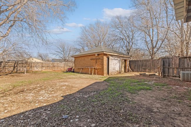 View of yard featuring central AC and a storage unit | Image 34