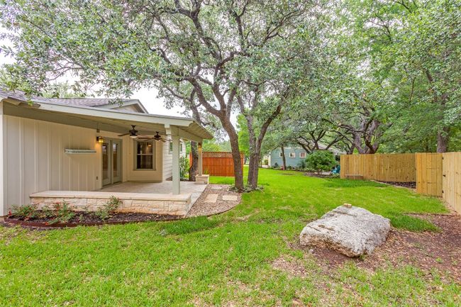 Fenced yard with a ceiling fan and a patio | Image 30