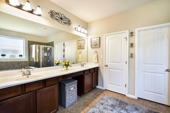Primary bath with double vanity and a very cool linen/beauty closet behind the left door. | Image 15
