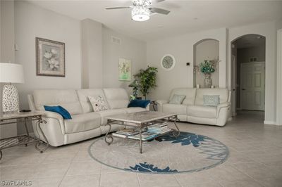 Living room featuring ceiling fan and light tile patterned floors | Image 2