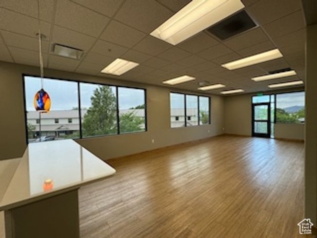 Empty room featuring a drop ceiling and wood finished floors | Image 38