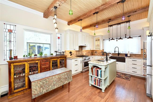 This beautiful Guest house kitchen has such unique lighting, stained glass windows and great extras. | Image 35