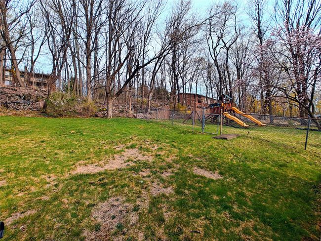 View of yard featuring fence and a playground | Image 6