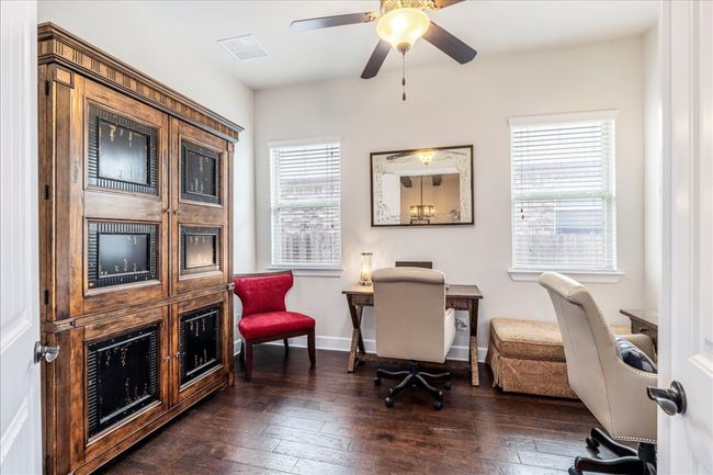 Office area featuring dark wood-style floors and a ceiling fan | Image 15