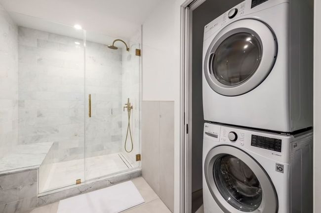 Washroom featuring stacked washer and dryer and laundry area | Image 13