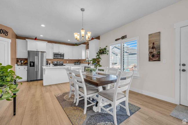 Dining room featuring recessed lighting, light wood-type flooring, baseboards, and a notable chandelier | Image 6
