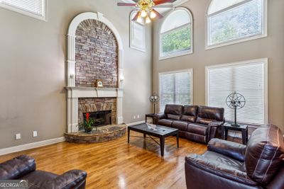 Light-Filled Family Room With A Stone Fireplace &amp; Floor-To-Ceiling Windows | Image 2