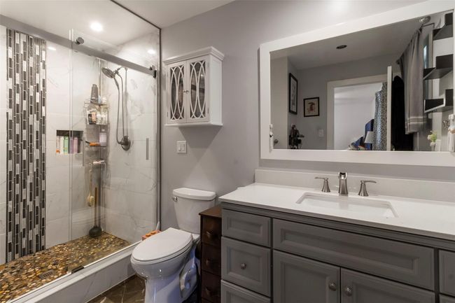 Full bath featuring toilet, vanity, a stall shower, and recessed lighting | Image 9