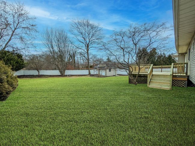 View of outbuilding featuring a fenced backyard and an outdoor structure | Image 28