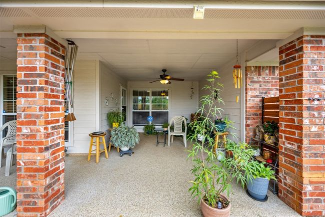 Covered porch featuring ceiling fan | Image 27