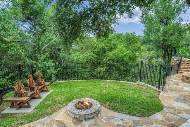 Fenced backyard with an outdoor fire pit and a patio area | Image 37