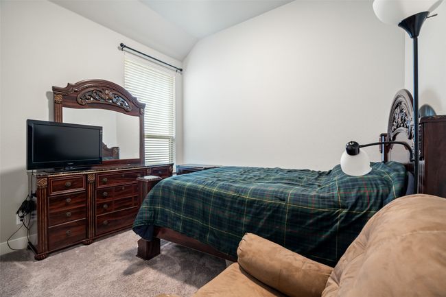 Carpeted bedroom featuring lofted ceiling | Image 13